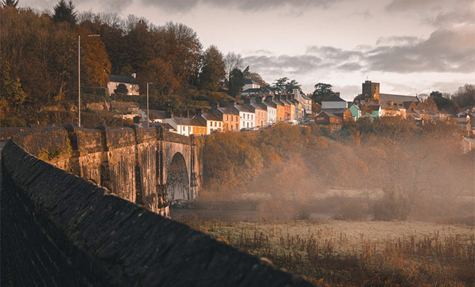 Misty day and colourful houses over the bridge at Llandeilo