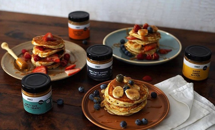 Stacks of pancakes drizzled in honey and topped with berries