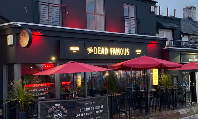Black exterior of bar in Newquay with names illuminated in lights
