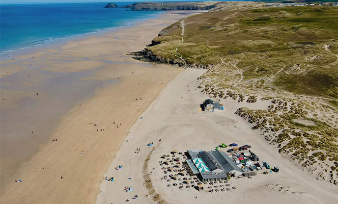 Ariel view of the UK's only bar on the beach, turquoise blue sea and golden white sand.
