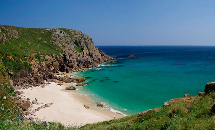Secluded sandy beach and turquoise waters at Porthchapel Beach