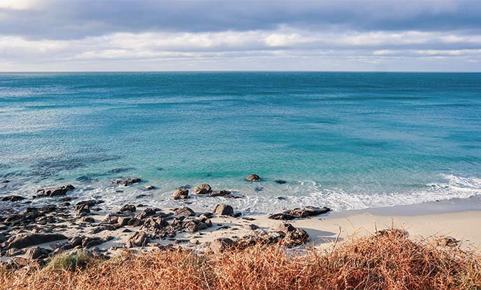 The beautiful sandy beach and turquoise sea of Sennen Cove