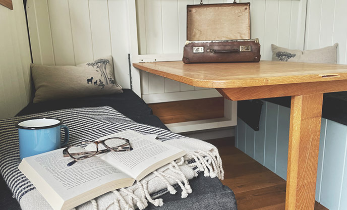 The table in Tamar Hut complete with a vintage suitcase welcome pack
