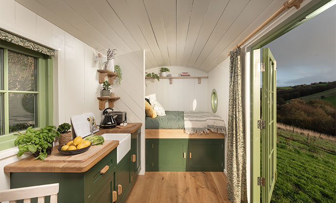 Pretty green interiors inside shepherds hut in Cornwall