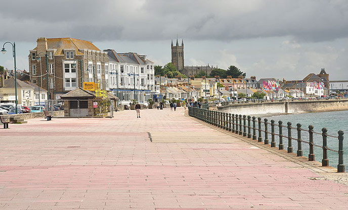 A view of Penzance promenade with the town in the in the distance