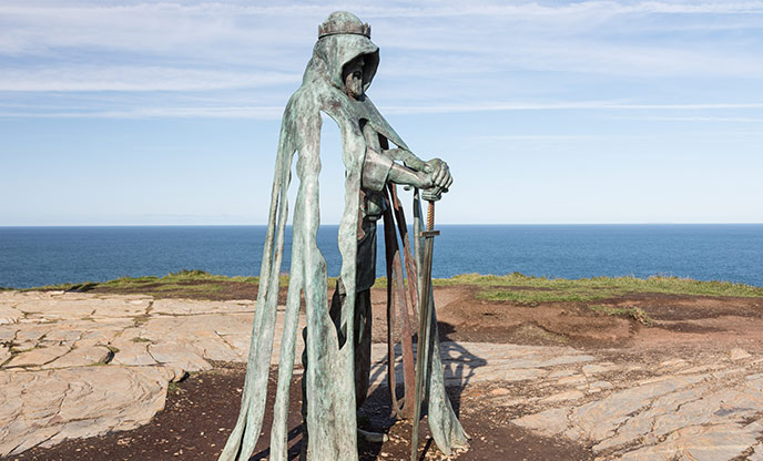 The eerie statue of King Arthur standing on top of the cliffs at Tintagel Castle