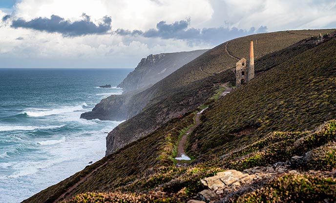 Looking across the cliffs at the famous Wheal Coates engine house as the waves break against the rocks below
