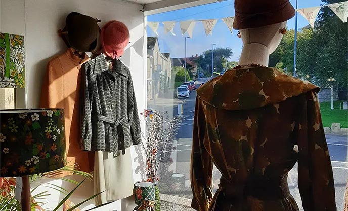 Inside the shop window of lady eve vintage in Helston on a sunny day