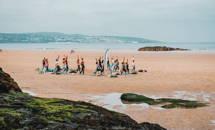 Yoga class on the beach in Cornwall