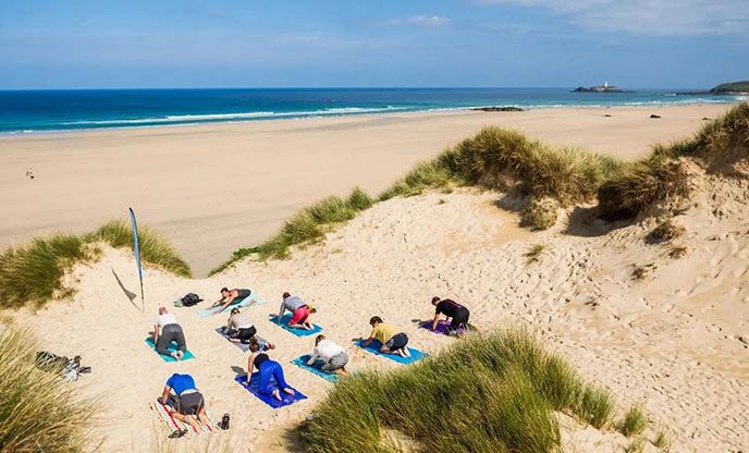 Yoga class on Gwithian Towans dunes by Alicia Ray