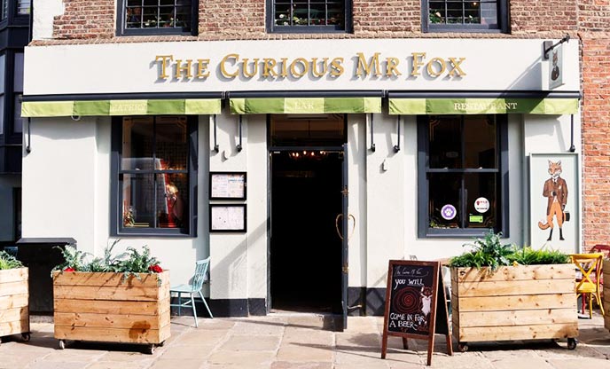 The white-washed façade of The Curious Mr Fox restaurant in Durham