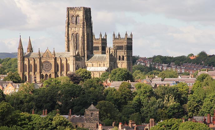 Durham Cathedral towering over rooftops and trees