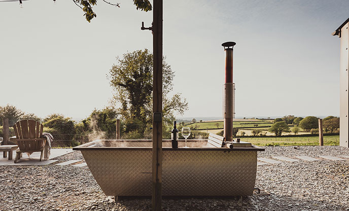 Wood-fired bath tub boasting views of the Devon countryside