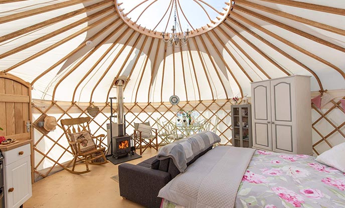 The interior of Rosewood Yurt with the stargazing window visible at the apex of the ceiling