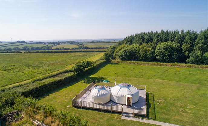 Two yurts situated in a green meadow