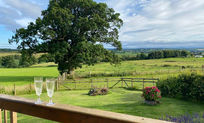 Prosecco on the decking of The Wagon with Faraway Views overlooking Dartmoor National Park