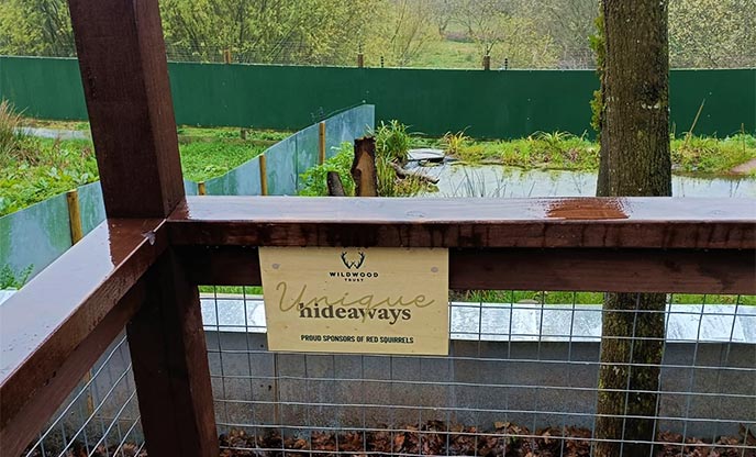 Unique hideaways sponsorship sign at the red squirrel walkway at Wildwood Devon 