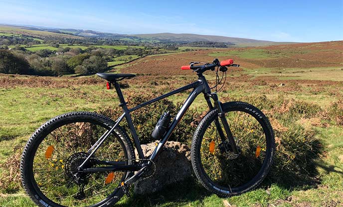 A bike with the rugged landscape of Dartmoor National Park in the background 