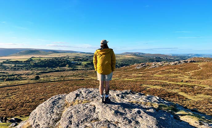Someone looking out over Dartmoor National Park from the top of Haytor while staying in Room With a View