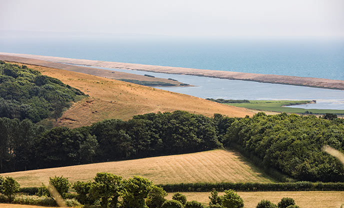 Looking over the patchwork of fields at the incredibly long Chesil beach in Dorset