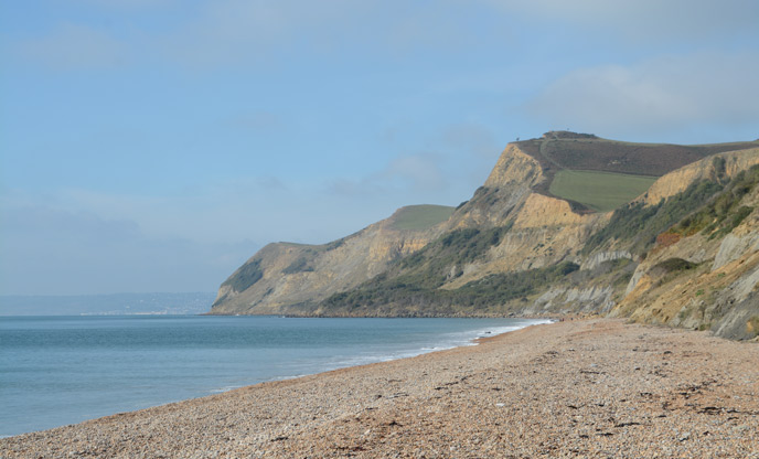 Looking up the beach at the towering cliffs at Golden Cap in Dorset