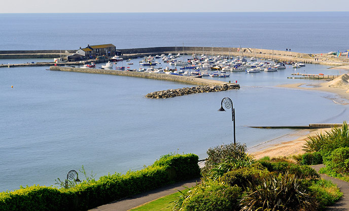 The glassy waters of Lyme Regis and the Cobb harbour 