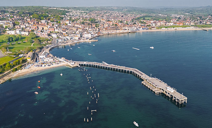 An aerial view of the beach and pier of Swanage in Dorset