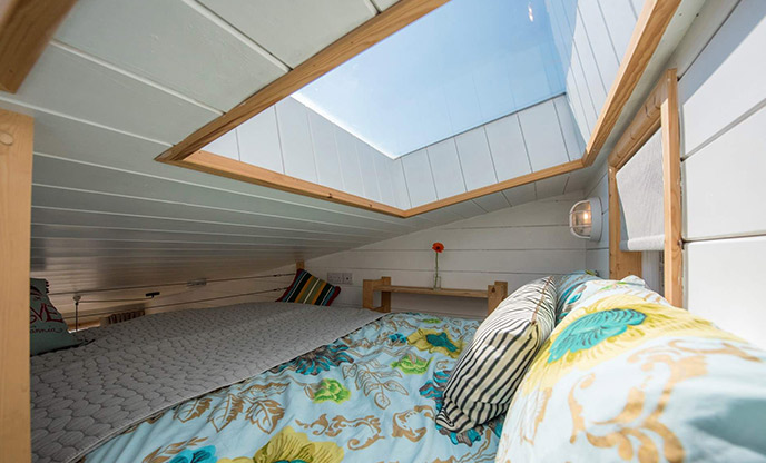 A skylight above the bed of Chalet on the Beach in Dorset. The bed is on the mezzanine of the chalet so the skylight is close. 