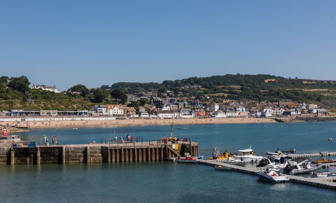 Looking out over the pontoon at the beach and seaside town of Lyme Regis in Dorset