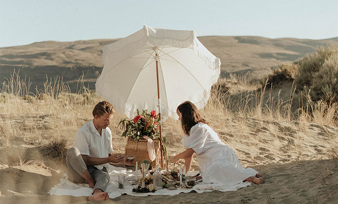 Couple having a picnic on the sand