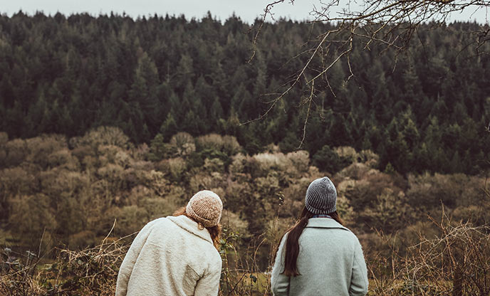 Two friends looking out towards woodland