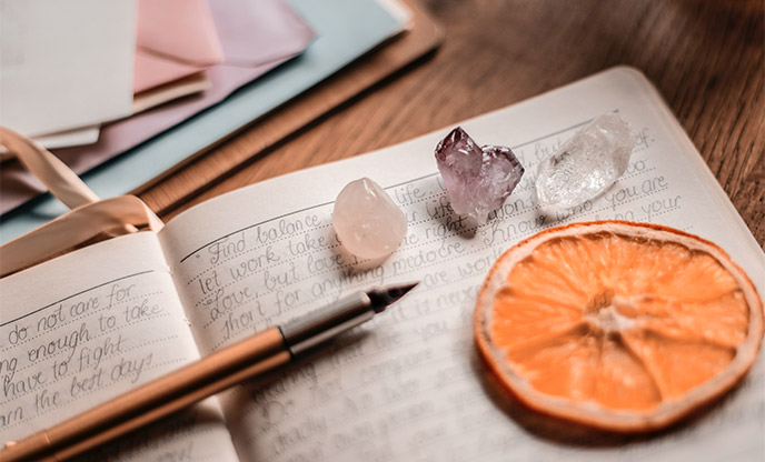 Writing in a journal with crystals