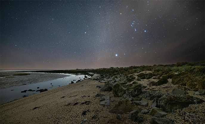 Star constellation over beach by Joseph Vary