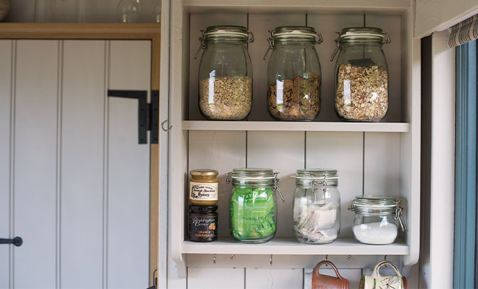 Shelves with jars containing food and powders