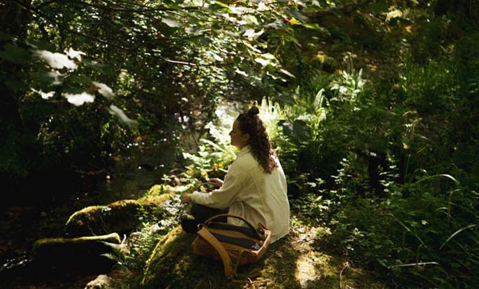 A person meditating in a forest 