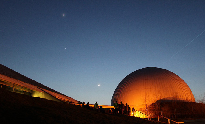 Moon and stars above the golden dome of Winchester Science Centre