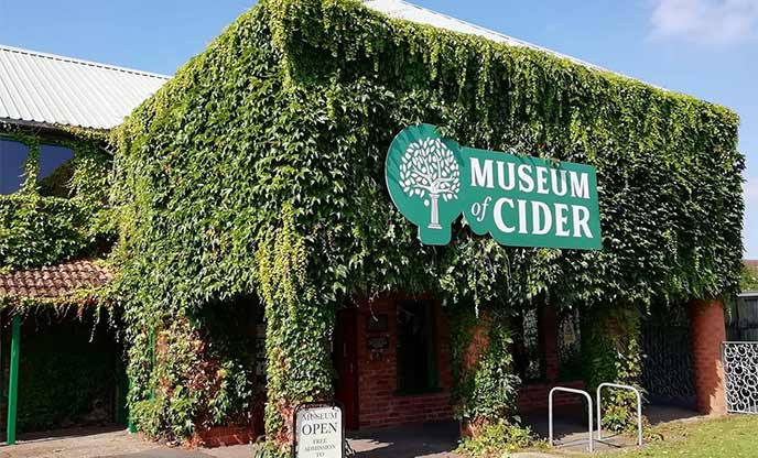 Exteriors of Museum of Cider covered with green leaves
