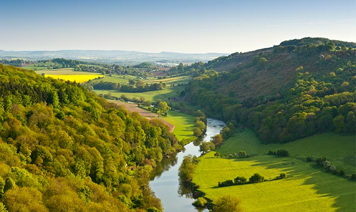 Ariel view of the winding River Wye, encompassed by lush rolling fields and woodland