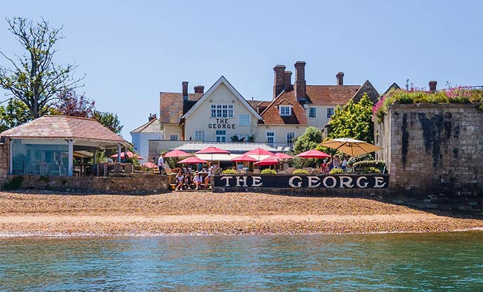 Beautiful sunny day at The George, a charming townhouse on the water's edge with glistening blue sea