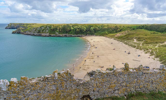 Long sandy beach with blue waters in Pembrokeshire