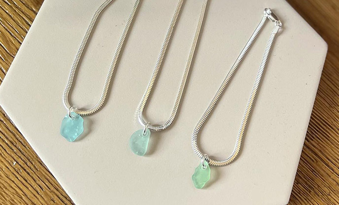 3 pieces of beautiful sea glass jewellery with shades of blue and emerald