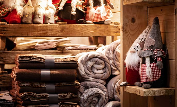 A Christmas market stall selling blankets and decorations