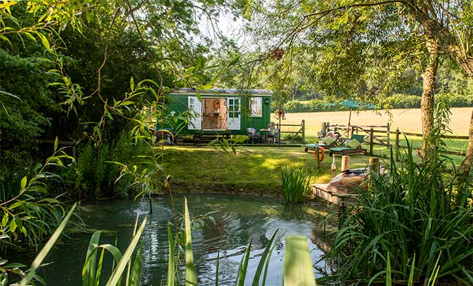 Peaceful shepherd's hut with its own small fishing lake, surrounded by trees