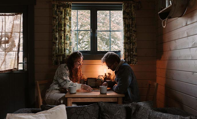 A couple playing boardgames into the evening