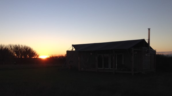 The sun setting behind Rusty the Tin Tent