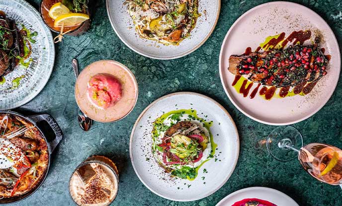 Array of colourful food and cocktails at Burnt Orange