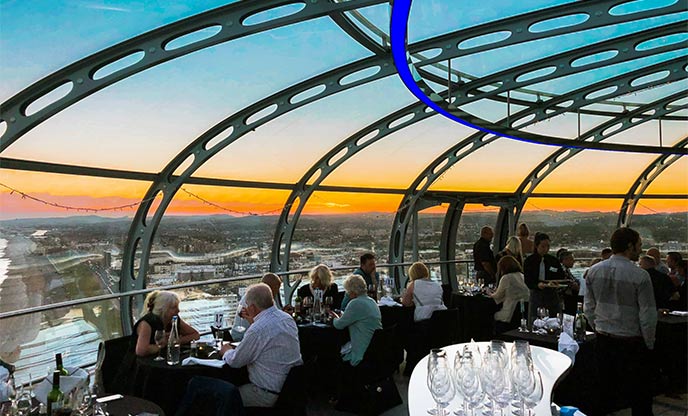 Inside dining at British Airways i360 as sun sets over Brighton