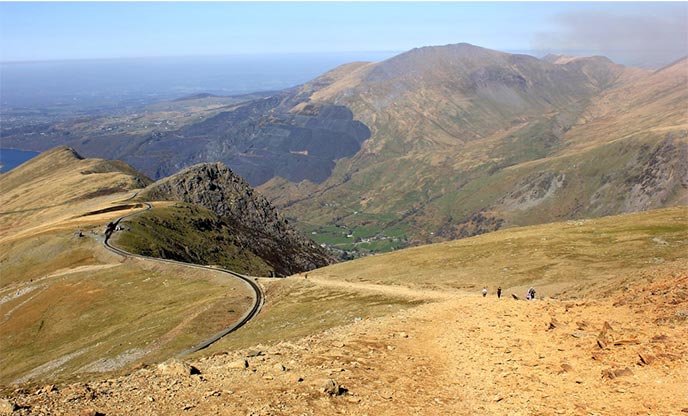 A foothpath in Snowdonia National Park with hills in the distance