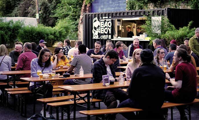 People sat outside drinking beer at the North Brewing Co taproom in Leeds