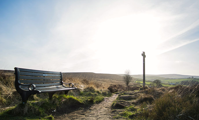 A wooden bench on a footpath through Haworth Moor in Yorkshire